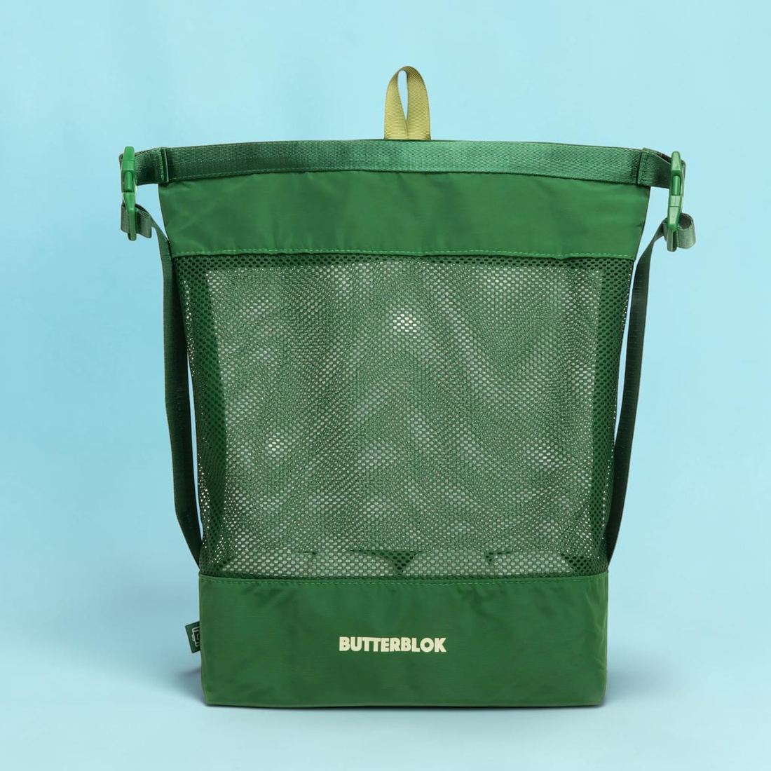 The green Butterblok Laundry Roll opened out into a tall mesh bag with a shoulder strap