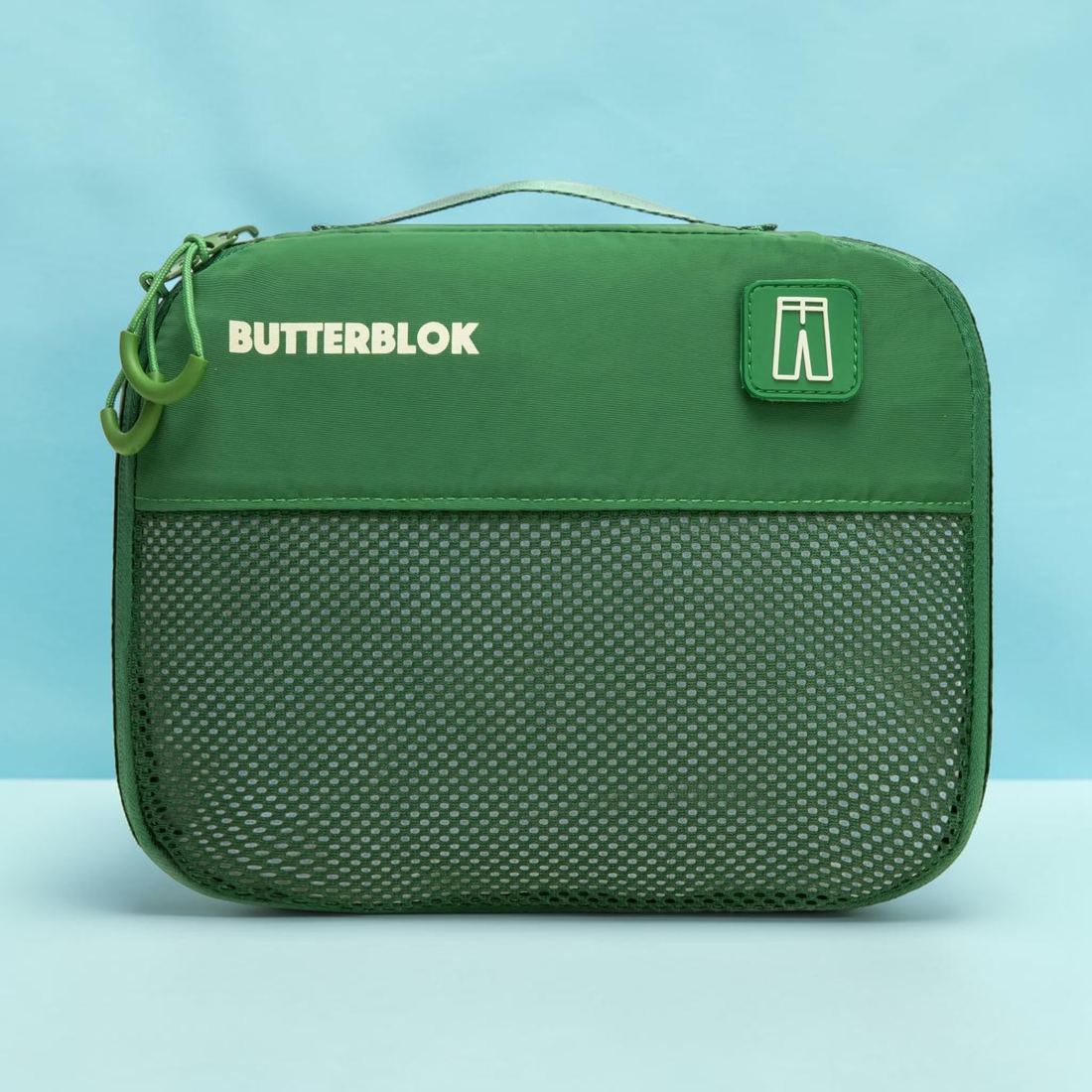 A green Butterblok Large cube with a trousers patch on the front