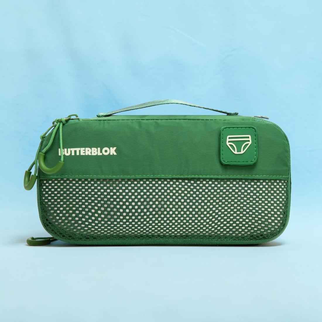 A slim green Butterblok Small cube with an underwear patch on the front